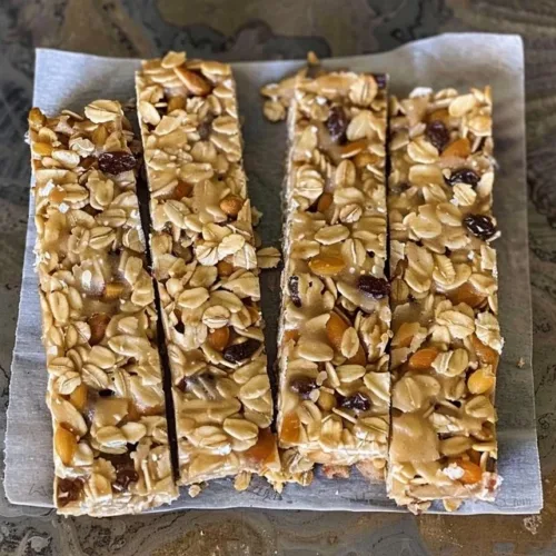 Chewy sourdough granola bars with oats and nuts on a wooden table