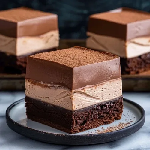 Decadent chocolate mousse brownies topped with chocolate ganache
