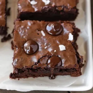 Delicious cocoa powder brownies on a plate, perfect for chocolate lovers.