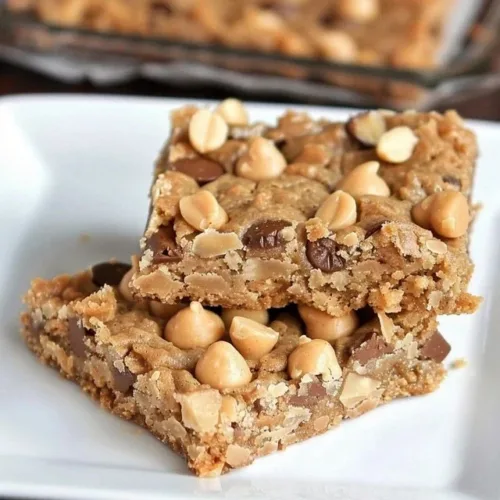 Deliciously crafted easy peanut butter cookie bars stacked on a plate.
