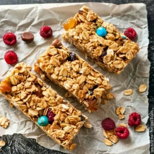 No bake granola bars stacked on a plate, showcasing healthy ingredients.