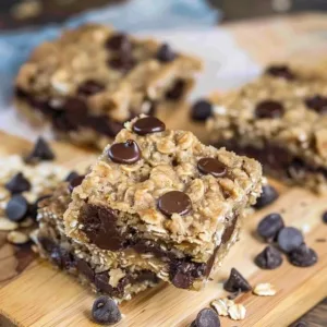Delicious homemade oatmeal chocolate chip bars on a wooden table.