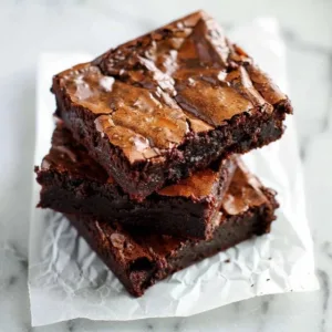 Delicious fudgy brownies on a plate, showcasing the perfect chocolatey texture.